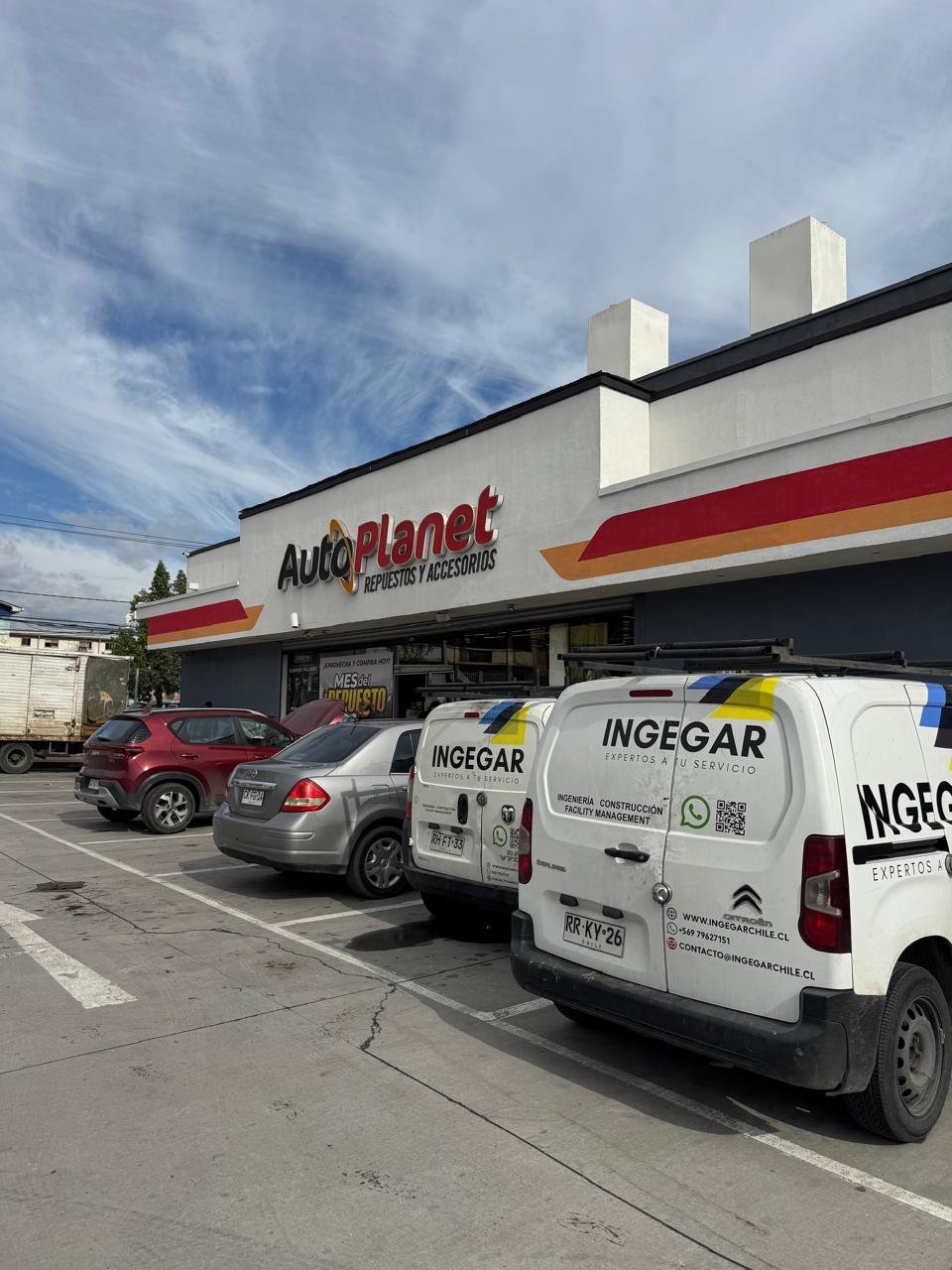 Furgones INGEGAR estacionados frente a un local AutoPlanet en Santiago